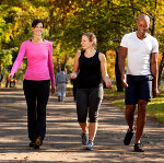 Three people walking in a park, getting some exercise